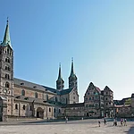 Der viertürmige Kaiserdom auf einem der sieben Hügel Bambergs ist das Herzstück der Stadt und das bedeutendste Kunstwerk im weiten Umkreis. Der Kaiserdom St. Peter und Georg geht auf eine Stiftung von Kaiser Heinrich II. zurück, der 1007 das Bistum Bamberg gründete. Zu den größten Sehenswürdigkeiten zählen das Papstgrab von Clemens II., die einzige vom Vatikan anerkannte Grablege eines Papstes nördlich der Alpen, und der Bamberger Reiter. Trotz zahlreicher Nachforschungen ist seine Identität bis heute nicht geklärt, noch viel weniger die des Künstlers.
Die Alte Hofhaltung, deren Kern die einstige Kaiser- und Bischofspfalz bildet, war früher direkt mit dem Dom verbunden. Durch die "Schöne Pforte" gelangt man in den von Fachwerkbauten umgebenen, romantischen Innenhof. Gleich gegenüber befindet sich der Rosengarten.
